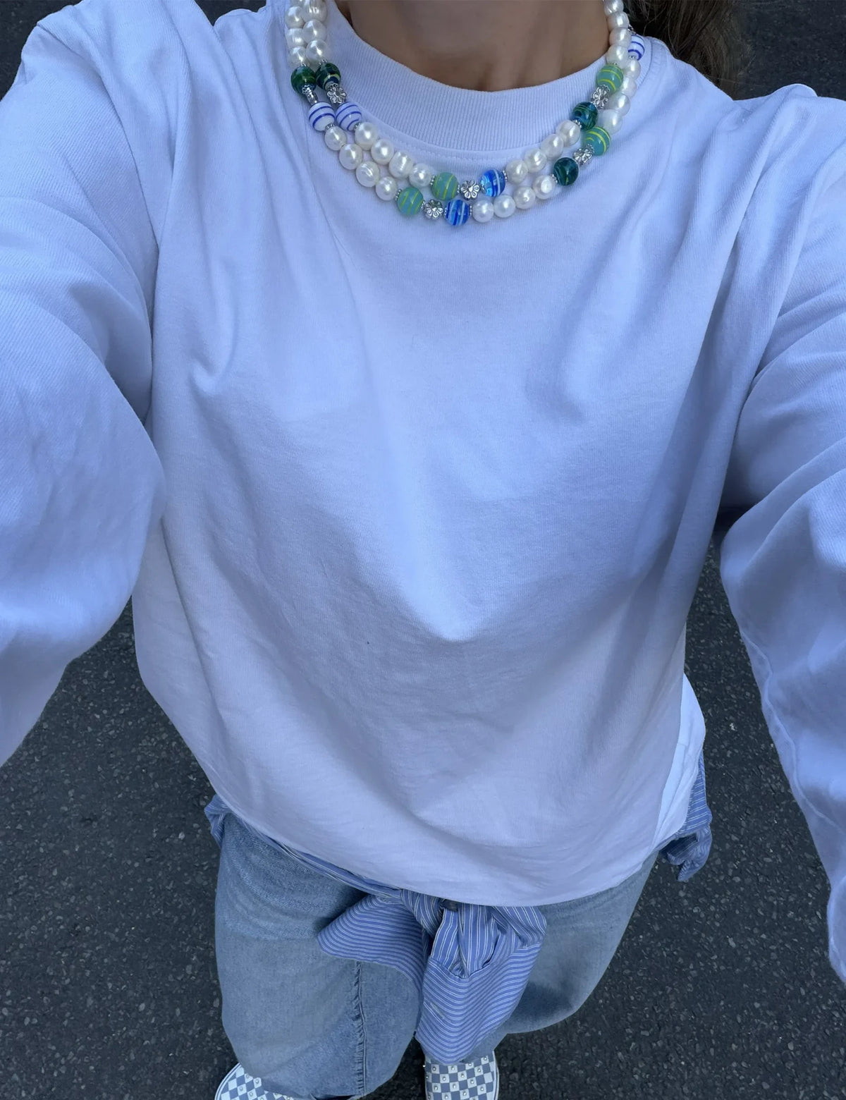 CODY necklaces worn layered with a white tee