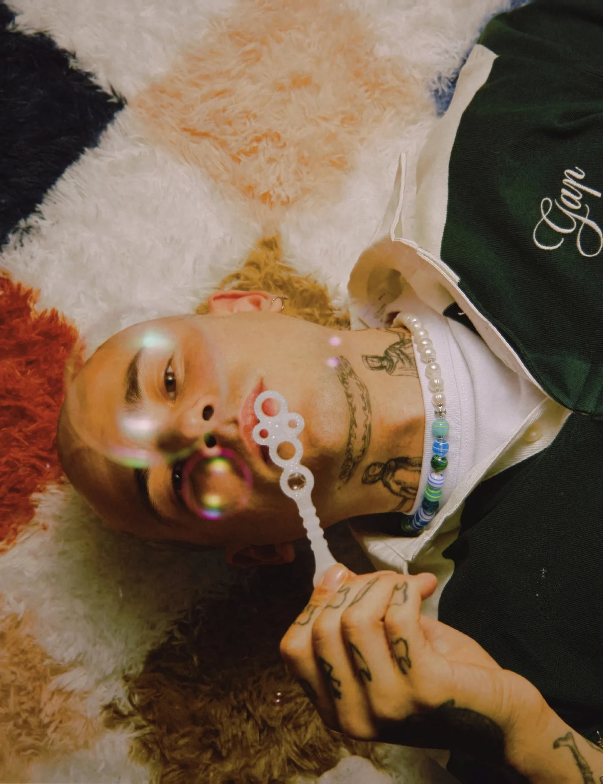 ZACK necklace worn, lying on a shaggy rug