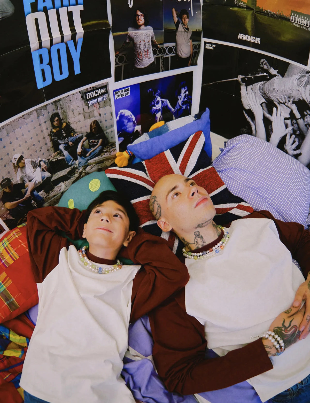 JIMMY necklaces worn by an adult and a child, lying on a bed