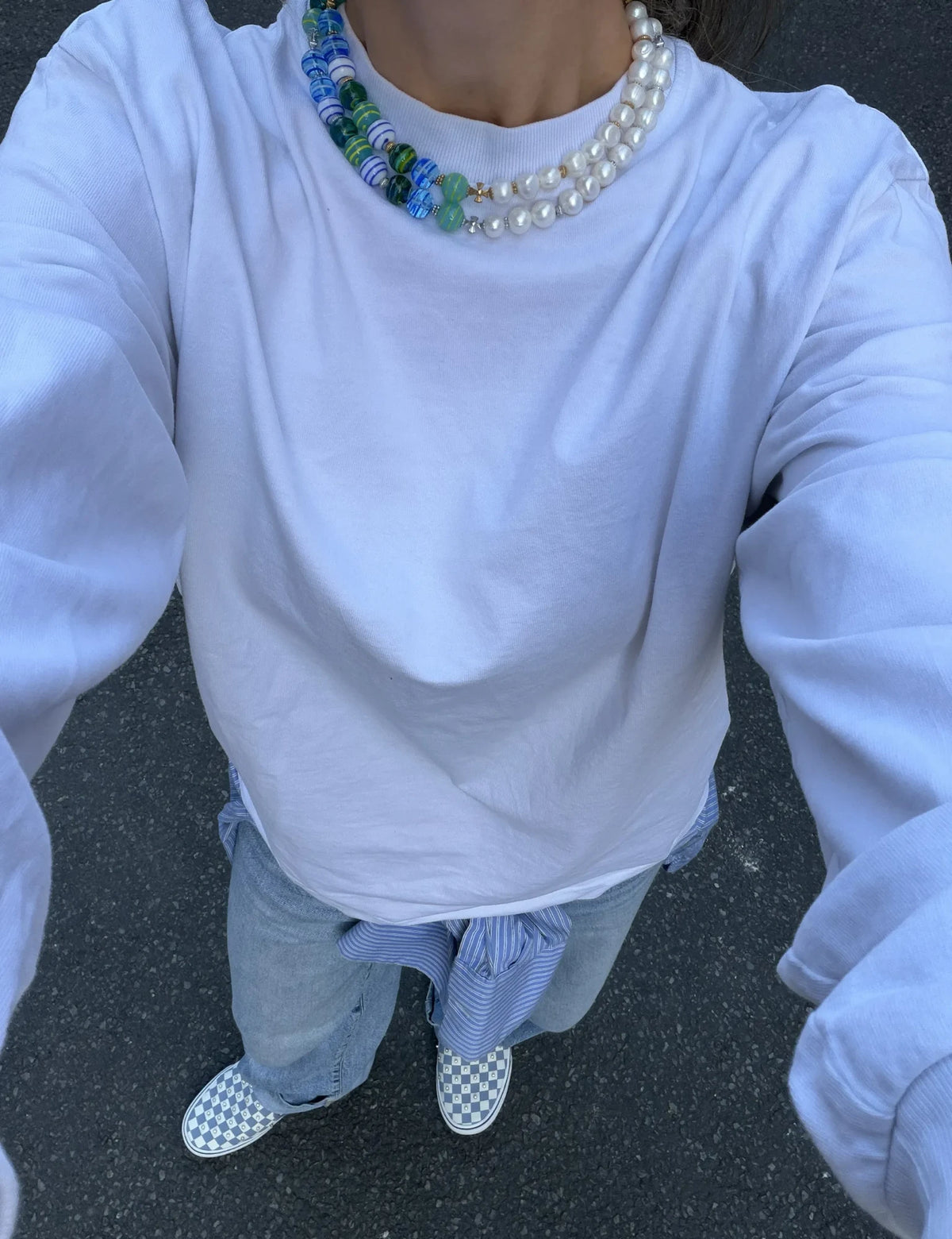 ZACK and ZACK GOLD necklaces worn layered with a white tee and checkerboard sneakers