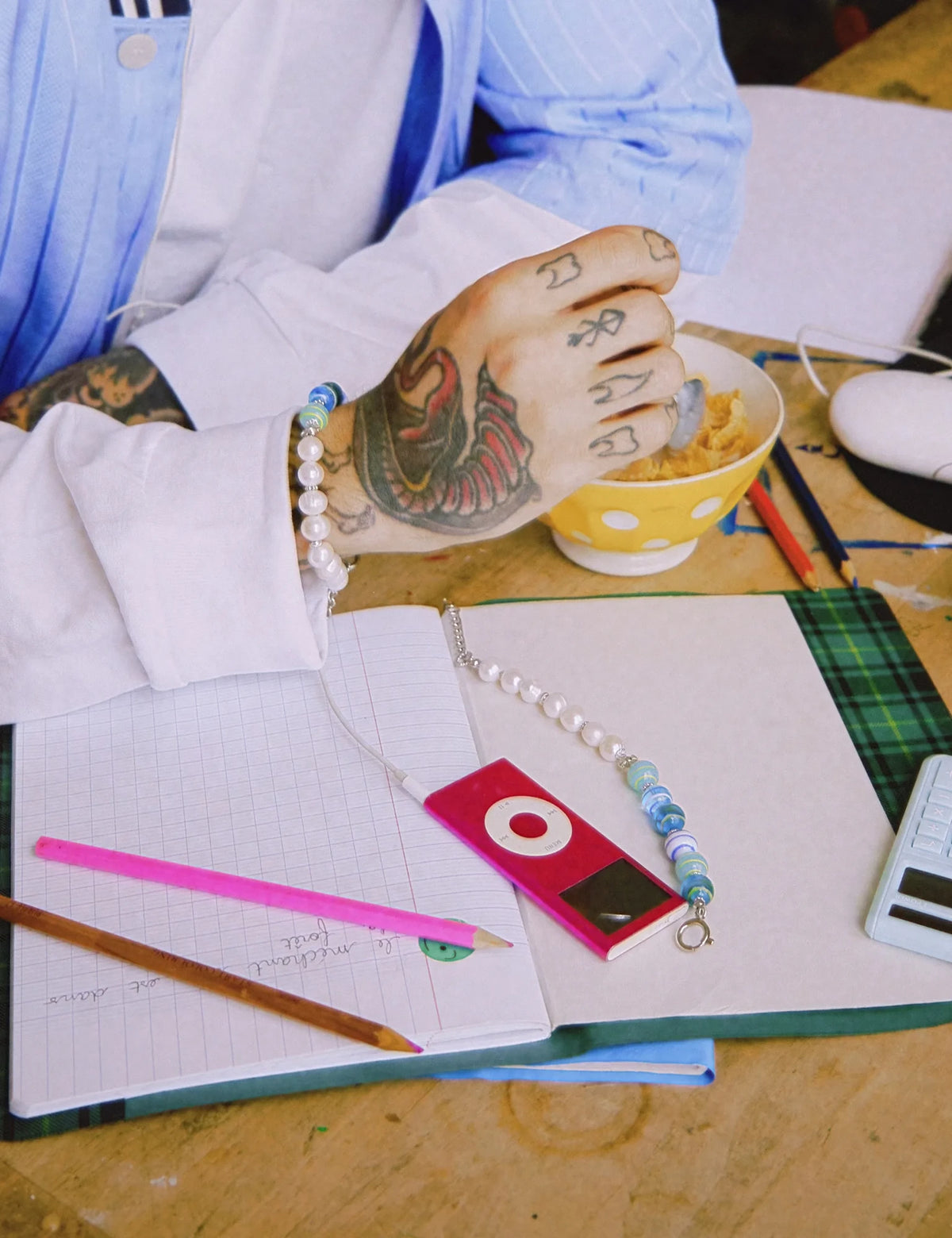 ZACK bracelets worn and laid on a school notebook