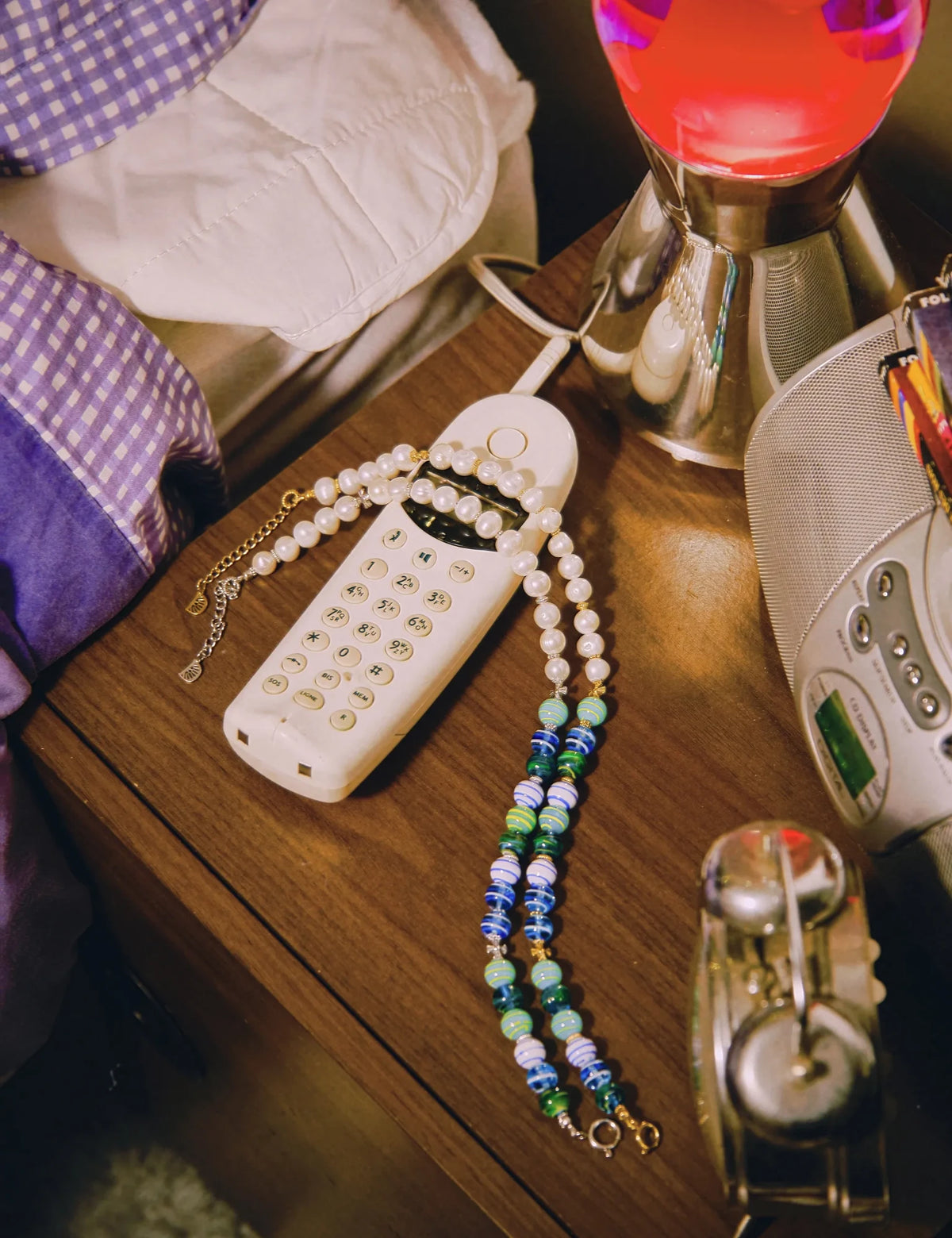 ZACK and ZACK GOLD necklaces on a bedside table